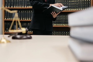 A criminal defense lawyer reading a criminal law book.