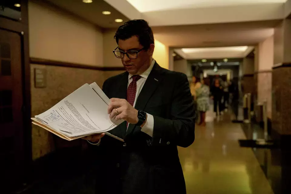 Criminal defense lawyer Daniel De La Garza reviewing criminal files in the Cadena-Reeves Justice Center located in San Antonio, Texas.